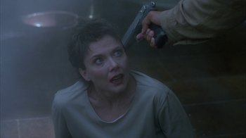 Movie still from “The Siege” (1998), directed by Edward Zwick – A woman with a gun pointed at her face; Close Up shot, Over the shoulder angle