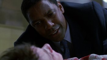 Movie still from “The Siege” (1998), directed by Edward Zwick – A person with a suit and tie; Close Up shot, Over the shoulder angle