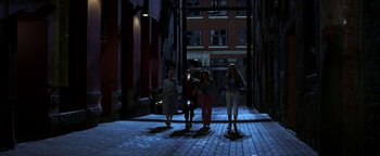 Movie still from “The Sisterhood of the Traveling Pants” (2005), directed by Ken Kwapis – A group of people walking down a street at night; Wide shot, Low angle