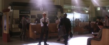 Movie still from “The Sisterhood of the Traveling Pants” (2005), directed by Ken Kwapis – A man in a suit standing next to another man in a suit; Wide shot, Low angle