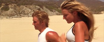 Movie still from “The Sisterhood of the Traveling Pants” (2005), directed by Ken Kwapis – A man and a woman running on the beach; Close Up shot, Low angle