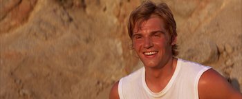 Movie still from “The Sisterhood of the Traveling Pants” (2005), directed by Ken Kwapis – A person with a white shirt smiling; Close Up shot, Over the shoulder angle