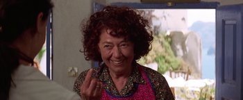Movie still from “The Sisterhood of the Traveling Pants” (2005), directed by Ken Kwapis – An older woman with curly red hair wearing an apron; Close Up shot, Low angle
