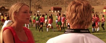 Movie still from “The Sisterhood of the Traveling Pants” (2005), directed by Ken Kwapis – A group of young people playing soccer on a field; Close Up shot, Over the shoulder angle