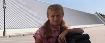 Movie still from “The Sisterhood of the Traveling Pants” (2005), directed by Ken Kwapis – A young girl with pigtails is holding a backpack; Close Up shot, Low angle