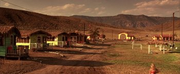 Movie still from “The Sisterhood of the Traveling Pants” (2005), directed by Ken Kwapis – A dirt road leading to a small village; Extreme Wide shot, High angle