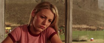 Movie still from “The Sisterhood of the Traveling Pants” (2005), directed by Ken Kwapis – A young woman sitting in front of a window; Close Up shot, Low angle