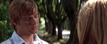 Movie still from “The Sisterhood of the Traveling Pants” (2005), directed by Ken Kwapis – A man and a woman standing next to each other in front of trees; Close Up shot, Over the shoulder angle