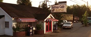 Movie still from “The Sisterhood of the Traveling Pants” (2005), directed by Ken Kwapis – A restaurant with a red and white striped awning; Wide shot, Low angle