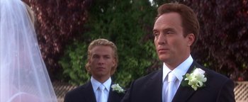 Movie still from “The Sisterhood of the Traveling Pants” (2005), directed by Ken Kwapis – A man in a suit and tie standing next to another man in a suit and tie; Close Up shot, Low angle