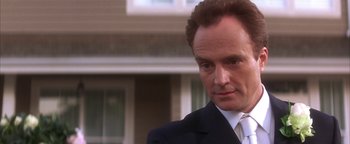 Movie still from “The Sisterhood of the Traveling Pants” (2005), directed by Ken Kwapis – A man in a suit and tie outside; Close Up shot, Low angle