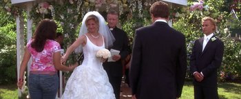 Movie still from “The Sisterhood of the Traveling Pants” (2005), directed by Ken Kwapis – A woman in a wedding dress holding a bouquet of flowers; Medium shot, Over the shoulder angle