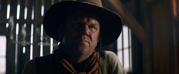 Movie still from “The Sisters Brothers” (2018), directed by Jacques Audiard – A person wearing a hat; Close Up shot, Low angle