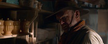 Movie still from “The Sisters Brothers” (2018), directed by Jacques Audiard – A person wearing a hat; Close Up shot, Over the shoulder angle