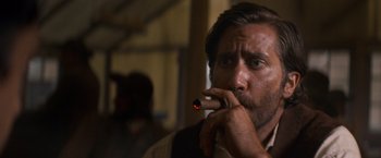 Movie still from “The Sisters Brothers” (2018), directed by Jacques Audiard – A person holding a cigar; Close Up shot, Low angle