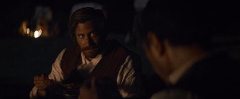 Movie still from “The Sisters Brothers” (2018), directed by Jacques Audiard – A man with a goatee is looking at himself in the mirror; Close Up shot, Over the shoulder angle