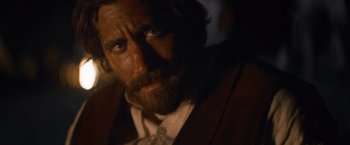 Movie still from “The Sisters Brothers” (2018), directed by Jacques Audiard – A person wearing a suit and tie; Close Up shot, Over the shoulder angle