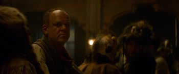 Movie still from “The Sisters Brothers” (2018), directed by Jacques Audiard – An older man is looking at the camera; Close Up shot, Over the shoulder angle