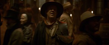 Movie still from “The Sisters Brothers” (2018), directed by Jacques Audiard – A man wearing a cowboy hat and a leather jacket; Medium shot, Low angle