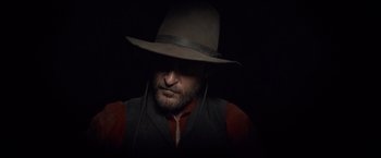 Movie still from “The Sisters Brothers” (2018), directed by Jacques Audiard – A man wearing a hat and a vest; Close Up shot, Low angle