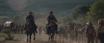 Movie still from “The Sisters Brothers” (2018), directed by Jacques Audiard – Two men on horseback are herding a herd of cattle; Extreme Wide shot, Low angle