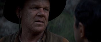 Movie still from “The Sisters Brothers” (2018), directed by Jacques Audiard – A person wearing a cowboy hat; Close Up shot, Low angle