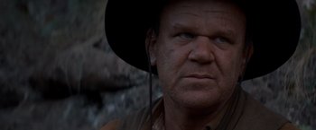 Movie still from “The Sisters Brothers” (2018), directed by Jacques Audiard – A person wearing a cowboy hat; Close Up shot, Low angle