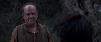 Movie still from “The Sisters Brothers” (2018), directed by Jacques Audiard – A man in a brown shirt is looking at another man in a brown shirt; Close Up shot, Over the shoulder angle