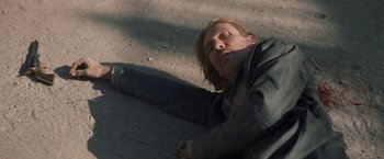 Movie still from “The Sisters Brothers” (2018), directed by Jacques Audiard – A man laying on the ground with his head down; Close Up shot, Overhead angle