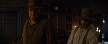 Movie still from “The Sisters Brothers” (2018), directed by Jacques Audiard – A man and a woman standing next to each other in a room; Medium shot, Over the shoulder angle
