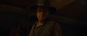 Movie still from “The Sisters Brothers” (2018), directed by Jacques Audiard – A person wearing a hat; Close Up shot, Low angle