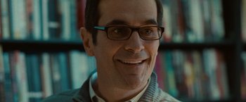 Movie still from “The Skeleton Twins” (2014), directed by Craig Johnson – A person wearing glasses and smiling; Close Up shot, Over the shoulder angle