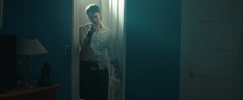 Movie still from “The Skeleton Twins” (2014), directed by Craig Johnson – A man standing in front of a mirror talking on a cell phone; Medium shot, Low angle