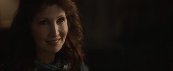 Movie still from “The Skeleton Twins” (2014), directed by Craig Johnson – A woman smiling for the camera; Close Up shot, Over the shoulder angle