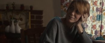 Movie still from “The Skeleton Twins” (2014), directed by Craig Johnson – A woman sitting on a chair in a living room; Close Up shot, Over the shoulder angle