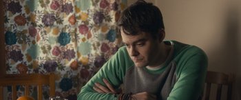 Movie still from “The Skeleton Twins” (2014), directed by Craig Johnson – A man sitting in front of a window with his arms crossed; Close Up shot, Over the shoulder angle