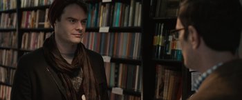 Movie still from “The Skeleton Twins” (2014), directed by Craig Johnson – A man standing in front of a book shelf; Close Up shot, Over the shoulder angle