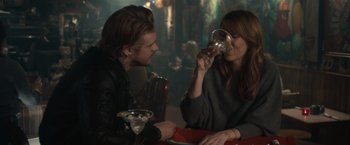 Movie still from “The Skeleton Twins” (2014), directed by Craig Johnson – A man and a woman sitting at a table with a drink; Medium shot, Over the shoulder angle