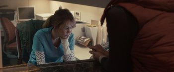 Movie still from “The Skeleton Twins” (2014), directed by Craig Johnson – A woman looking in the mirror while holding a cell phone; Medium shot, Over the shoulder angle