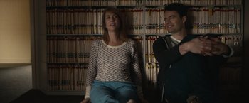 Movie still from “The Skeleton Twins” (2014), directed by Craig Johnson – A woman and a man sitting in front of a book case; Medium shot, Over the shoulder angle