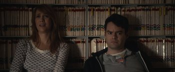 Movie still from “The Skeleton Twins” (2014), directed by Craig Johnson – A man and a woman standing in front of a book case; Close Up shot, Over the shoulder angle