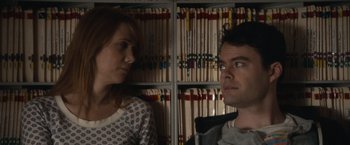 Movie still from “The Skeleton Twins” (2014), directed by Craig Johnson – A man and a woman standing next to each other in front of a bookshelf; Close Up shot, Over the shoulder angle