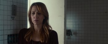 Movie still from “The Skeleton Twins” (2014), directed by Craig Johnson – A woman standing in front of a bathroom door; Close Up shot, Over the shoulder angle