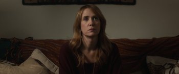 Movie still from “The Skeleton Twins” (2014), directed by Craig Johnson – A woman sitting on top of a couch in front of a window; Close Up shot, Over the shoulder angle