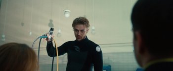 Movie still from “The Skeleton Twins” (2014), directed by Craig Johnson – A man in a black wetsuit holding a yellow hose; Medium shot, Low angle