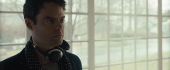 Movie still from “The Skeleton Twins” (2014), directed by Craig Johnson – A person wearing headphones near a window; Close Up shot, Over the shoulder angle