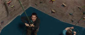 Movie still from “The Skeleton Twins” (2014), directed by Craig Johnson – A man holding a rope while standing on a wall; Medium shot, Overhead angle