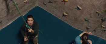 Movie still from “The Skeleton Twins” (2014), directed by Craig Johnson – A man is climbing up the side of a rock wall; Wide shot, Overhead angle