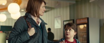 Movie still from “The Skeleton Twins” (2014), directed by Craig Johnson – A woman and a child are standing together; Medium shot, Over the shoulder angle