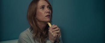 Movie still from “The Skeleton Twins” (2014), directed by Craig Johnson – A woman holding a banana in her hands; Close Up shot, High angle